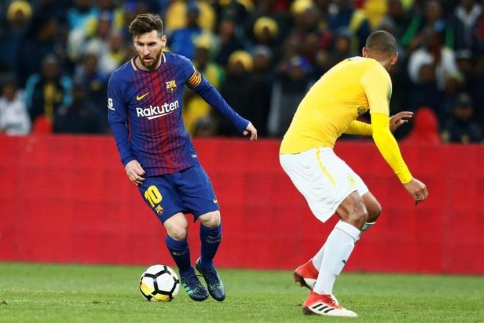 Argentine superstar Lionel Messi (L) playing for Barcelona last year at Soccer City, the Soweto stadium with a 90,000 capacity