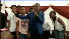 “My name is prophet Nicholas, son of prof Daniel” – Pastor brags as he tears bible, feeds it to members (video)