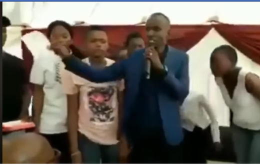“My name is prophet Nicholas, son of prof Daniel” – Pastor brags as he tears bible, feeds it to members (video)