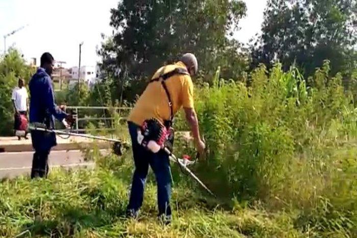 Mahama clears weeds in front of new Military Cemetary