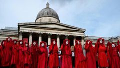 Extinction rebellion activists -- seen on the steps of the National Gallery in London's Trafalgar Square -- said hundreds of their number would occupy London City Airport from Thursday morning until Saturday night