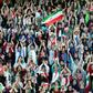 Wearing sporty hats and the national flag, Iranian women cheer for their team at a game they will never forget.