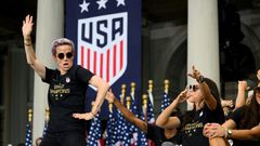 US women's soccer star Megan Rapinoe, left, and her teammates won a court ruling Friday in their fight for equal pay from the US Soccer Federation