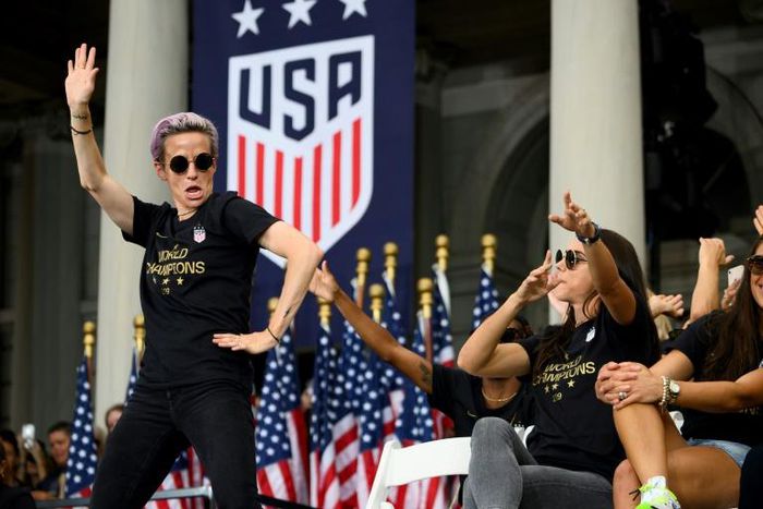 US women's soccer star Megan Rapinoe, left, and her teammates won a court ruling Friday in their fight for equal pay from the US Soccer Federation