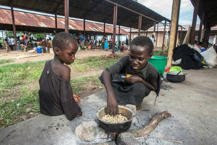 Homeless: Children cook corn at a camp for displaced people in Bangula, southern Malawi