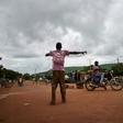 A Malian activist directs traffic on August 27, with the main road between the capital of Bamako and the western city of Kayes closed due to protest
