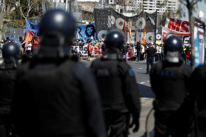 Riot police face off against demonstrators in Buenos Aires, during a protest against the economic policies Argentine President Mauricio Macri. Argentina will hold presidential elections next October 27.