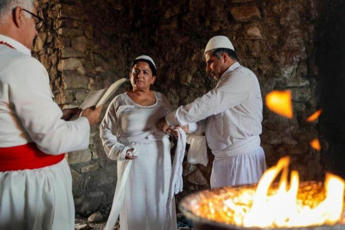 Iraqi Kurd Faiza Fouad takes part in a ritual ceremony in an ancient and ruined temple as she joins the millennia-old Zoroastrian religion