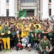 Rainbow nation: Springbok scrum half Faf de Klerk holds the William Webb Ellis Trophy alongside his teammates outside the South African parliament in Cape Town