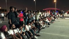 Indian fans who could not get tickets watch on a giant screen outside the stadium where Qatar play India in a World Cup tie