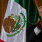 Mexican President Andres Manuel Lopez Obrador waves a Mexican flag at Independence Day celebrations in Mexico City on September 15, 2019