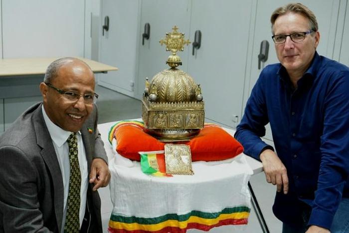 The ornate gilded copper crown, featuring images of Jesus and the Apostles, was unearthed after refugee-turned-Dutch-citizen Sirak Asfaw (L) contacted Dutch 'art detective' Arthur Brand (R)