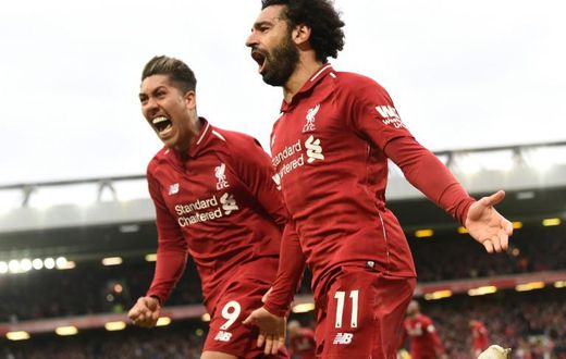 Liverpool's Mohamed Salah (right) and Roberto Firmino (left) celebrate a huge win for their title ambitions