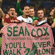 Liverpool players hold a tribute to fan Sean Cox