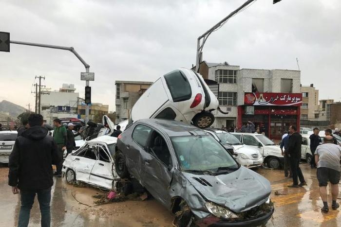 Cars pilled up in a street of the southern Iranian city of Shiraz where at least 11 people were killed and 68 injured in flooding
