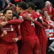 Liverpool players celebrate after a late own goal from Toby Alderweireld gave them a 2-1 victory against Tottenham