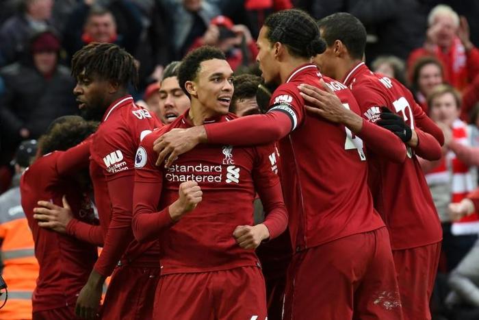 Liverpool players celebrate after a late own goal from Toby Alderweireld gave them a 2-1 victory against Tottenham
