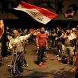 Iraqi protesters wave the national flag as they take part in anti-government demonstrations in central Baghdad's Tahrir Square