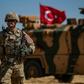 A US soldier stands guard during a joint patrol with Turkish troops in northeastern Syria