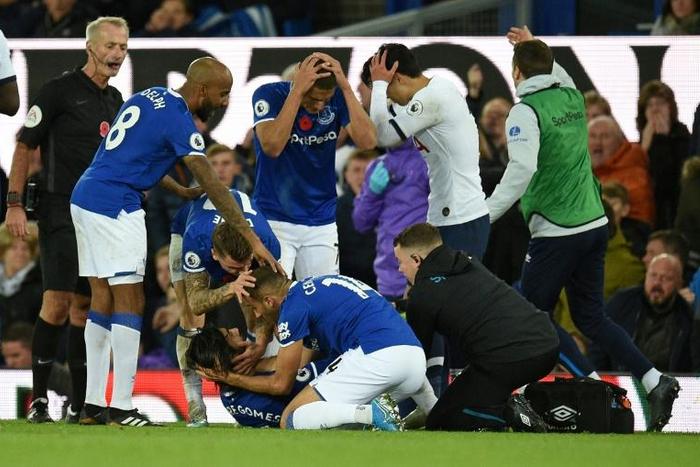 Everton's Andre Gomes (on the floor) has been released from hospital just two days after suffering a broken ankle