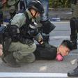 Police detain a demonstrator during protests in Hong Kong's Tuen Mun district