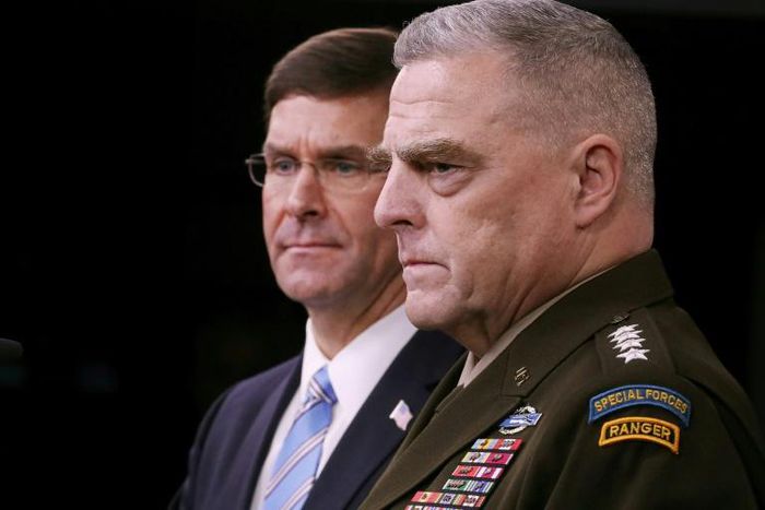 General Mark Milley (R), chairman of the US Joint Chiefs of Staff, is seen  with Defense Secretary Mark Esper at an October 28, 2019 Pentagon news briefing on the death of IS leader Abu Bakr al-Baghdadi; Milley says 500 US troops will remain in Syria