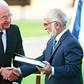Jordan's King Hussein (R) and Israeli Premier Yitzhak Rabin shake hands after exchanging the documents of the peace treaty on the southern shore of the Sea of Galilee