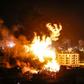 Fire and smoke billow above buildings in Gaza City during reported Israeli strikes on March 25, 2019