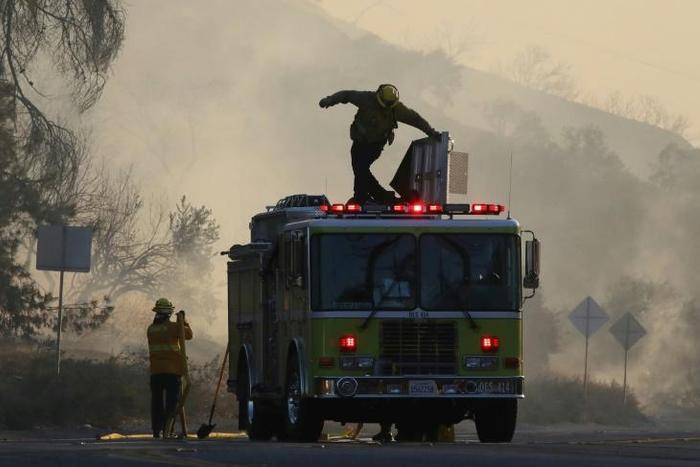 Firefighters work during the Tick Fire on October 24, 2019 in Canyon Country, California.