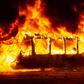 A bus burns in downtown Santiago. Protests over metro fare increases escalated into clashes with riot police, with subway stations torched and vandalised
