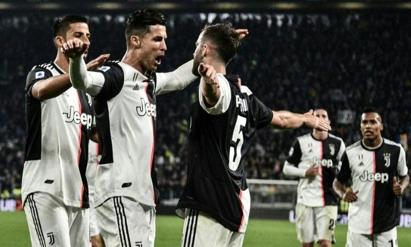 Cristiano Ronaldo and Miralem Pjanic celebrate scoring