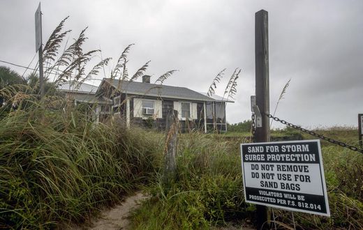 Churning North, Hurricane Drubs Weary Carolinas