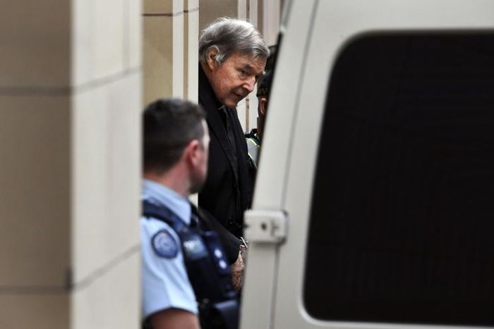 Australian Cardinal George Pell is escorted in handcuffs from the Supreme Court of Victoria in Melbourne on August 21, 2019.
