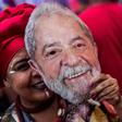 A supporter of Brazil's Workers Party holds a mask with the face of imprisoned former Brazilian president Luiz Inacio Lula da Silva