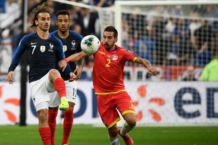 Antoine Griezmann (L) missed a penalty but later set up a goal as France eased to a 3-0 win over lowly Andorra in Euro 2020 qualifying