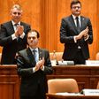 Romanian Prime Minister Ludovic Orban is applauded by members of his cabinet after a vote for a new government at the Romanian Parliament in Bucharest on November 4, 2019