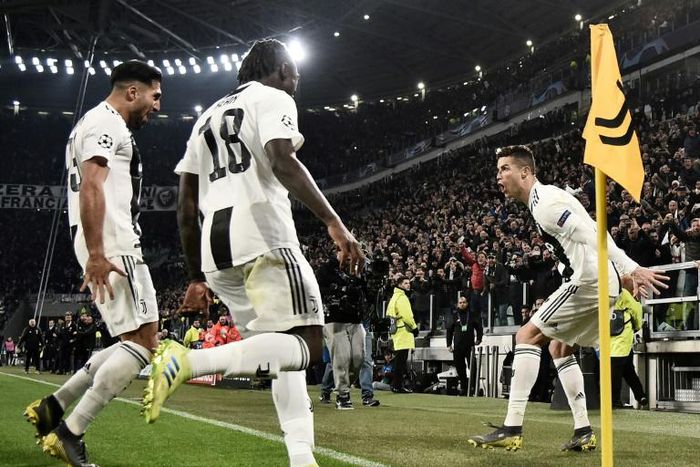 Cristiano Ronaldo celebrates with Emre Can and Moise Kean after scoring a hat-trick in the Champions League against Atletico Madrid