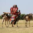 Sudanese villagers carry belongings on camels in the Darfur village of Shattaya following their return home last year after more than a decade of being displaced by war