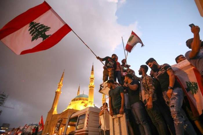 Hundreds of thousands of people have joined protests demanding a sweeping overhaul of Lebanon's political system
