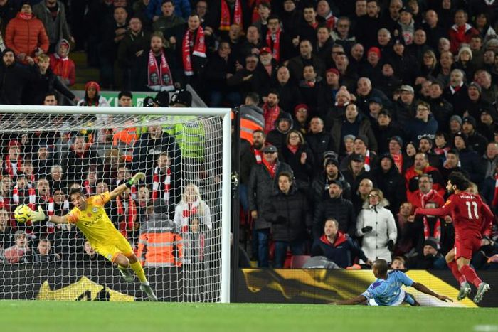 A Mohamed Salah (R) header beats Manchester City goalkeeper Claudio Bravo to give Liverpool a two-goal lead in an English Premier League clash at Anfield