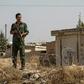 Kurdish security forces stand guard during a demonstration by Syrian Kurds against Turkish threats of a military operation in northern Syria