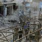 Turkey-backed Syrian fighters inspect the site of a car bomb explosion in the northern Syrian town of Tal Abyad, on the border with Turkey, on Saturday