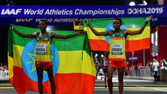 Migrant workers turned out in force to support runners from their native countries at the World Athletics Championships men's marathon in Doha, which saw Ethiopia's Lelisa Desisa (L) win gold