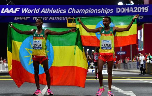 Migrant workers turned out in force to support runners from their native countries at the World Athletics Championships men's marathon in Doha, which saw Ethiopia's Lelisa Desisa (L) win gold