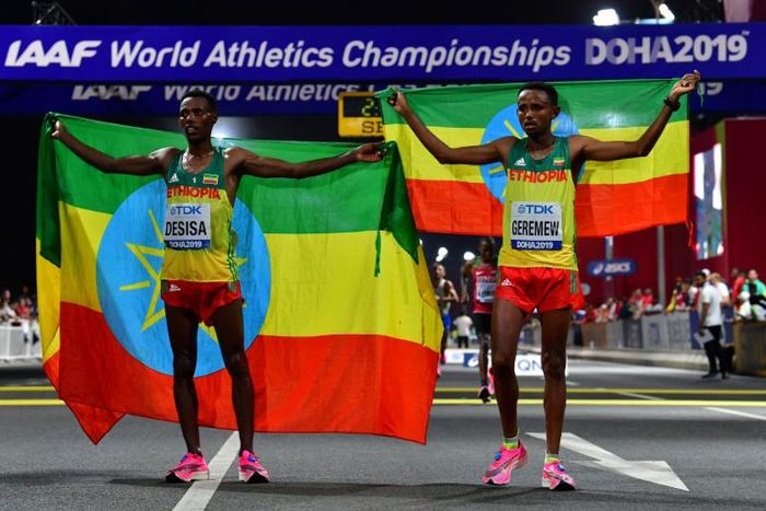 Migrant workers turned out in force to support runners from their native countries at the World Athletics Championships men's marathon in Doha, which saw Ethiopia's Lelisa Desisa (L) win gold