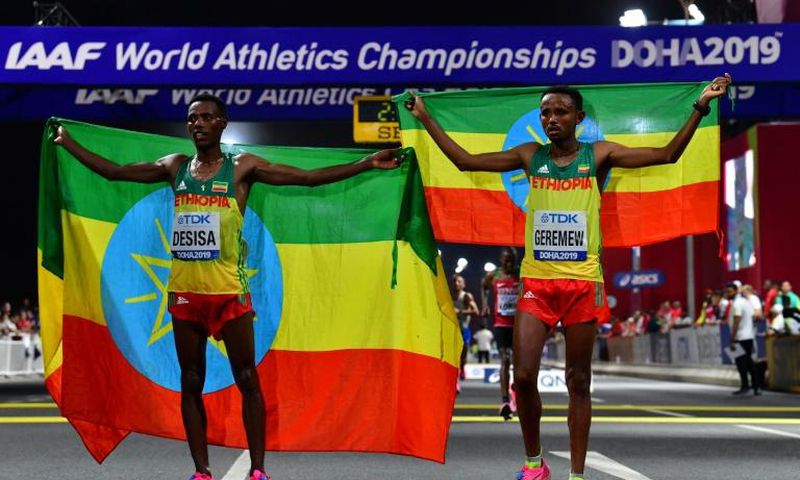 Migrant workers turned out in force to support runners from their native countries at the World Athletics Championships men's marathon in Doha, which saw Ethiopia's Lelisa Desisa (L) win gold