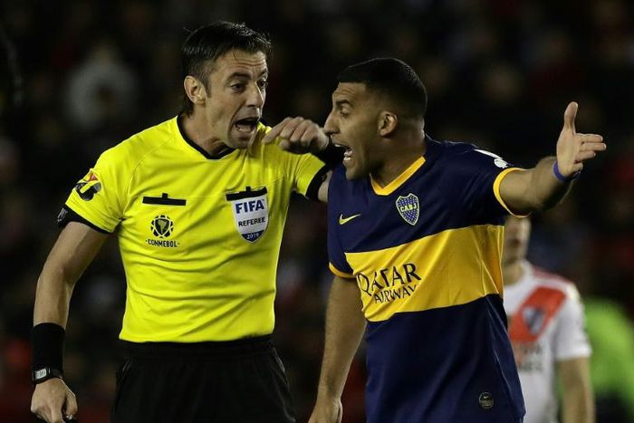 Boca Juniors forward Ramon Abila (right) remonstrates with Brazilian referee Raphael Claus during the Copa Libertadores semi-final, first leg defeat to River Plate