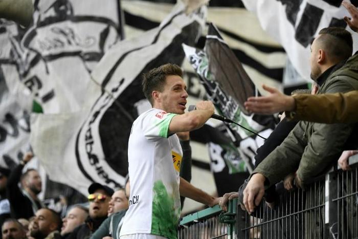 Moenchengladbach's double hero Patrick Herrmann celebrates with fans