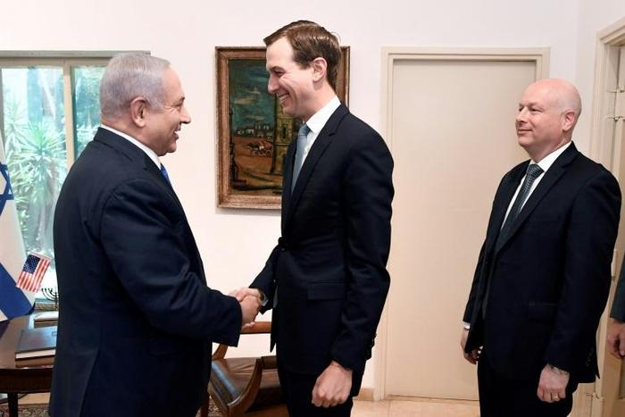 Jared Kushner (C) shakes hands with Israeli Prime Minister Banjamin Netanyahu (L) in Jerusalem as US special representative Jason Greenblatt looks on May 30, 2019