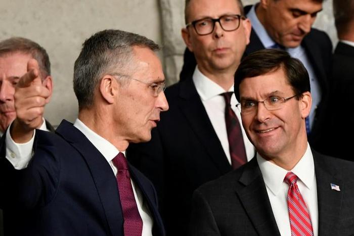 NATO Secretary General Jens Stoltenberg (L) talks with US Defense Secretary Mark Esper (R) during a NATO defence ministers meeting, at the NATO headquarters in Brussels